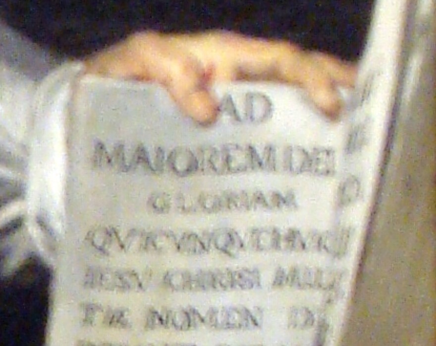 Detail of the Rubens painting: the open book under the saint's hand, inscribed AD MAIOREM DEI GLORIAM
